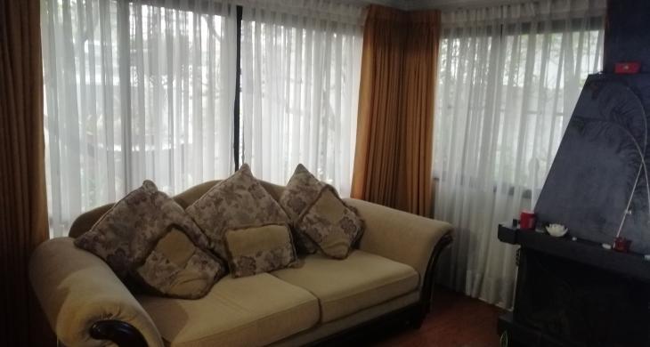 amplio living, con amplios ventanales con protecciones